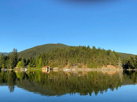 Perfect reflection of a small hill in Bargain Bay, near Pender Harbour Stock Photos