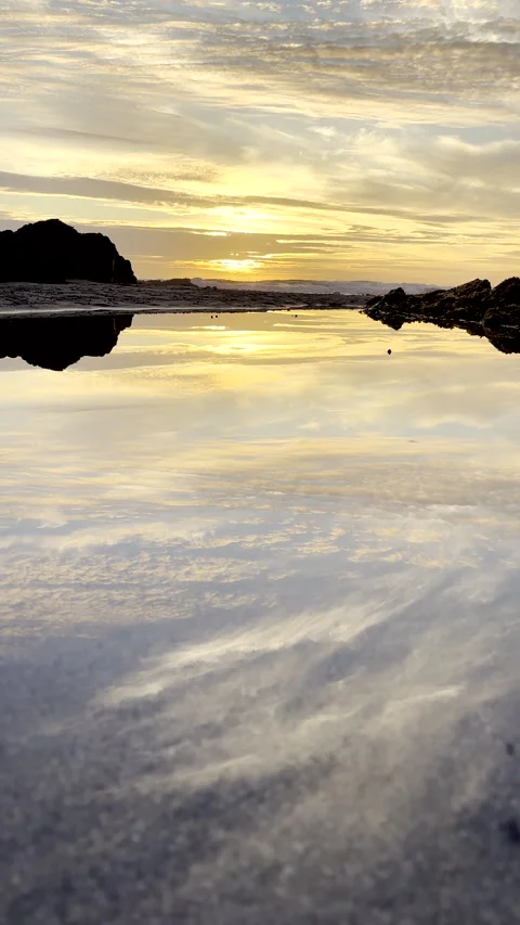 Perfect sunset golden hour reflection in shallow marine pool on beach Stock Footage 329208939