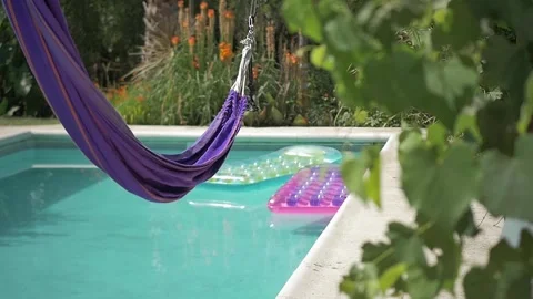 Perfect swimming pool surrounded by a beautiful garden on BnB Stock Footage 255862018