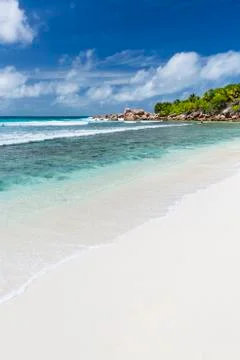 Perfect white beach Anse Cocos in La Digue, Seychelles with granite boulders  Stock Photos