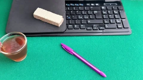 The Perfect Work Setup: Tea, Keyboard, and a Quick Snack Video stock 327775299