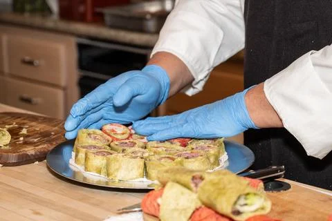 Perfecting the snacks for the guests. Stock Photos