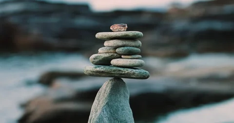 A Perfectly Balanced Stack of Smooth Stones Forming a Cairn, Symbolizing Stock Footage 339341134