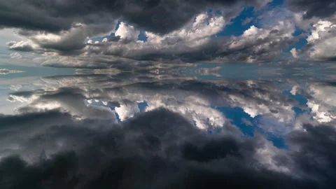 Perfectly mirrored clouds reflected into a symmetrical sky create a calming... Stock Footage 340199323