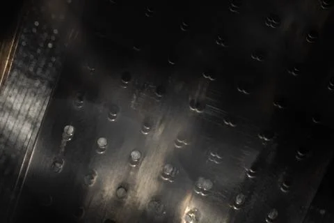 Perforated black metal surface with motion blur and reflected light for abs.. Foto stock