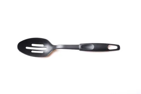Perforated black plastic spoon Stock Photos