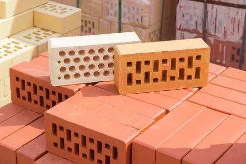 Perforated bricks of different colors and shapes of holes Stock Photos