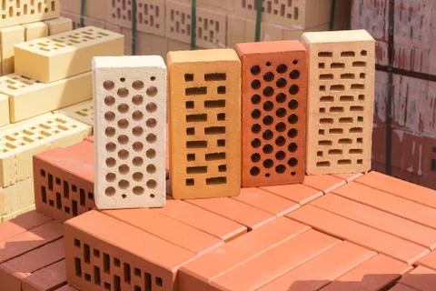 Perforated bricks of different colors and shapes of holes Stock Photos