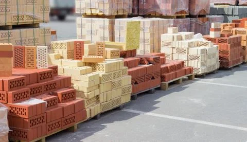 Perforated bricks of different colors and shapes of holes Stock Photos