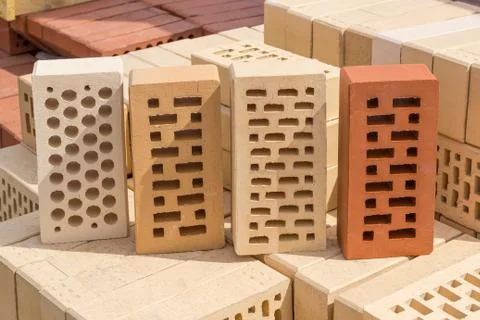 Perforated bricks of different colors and shapes of holes Stock Photos