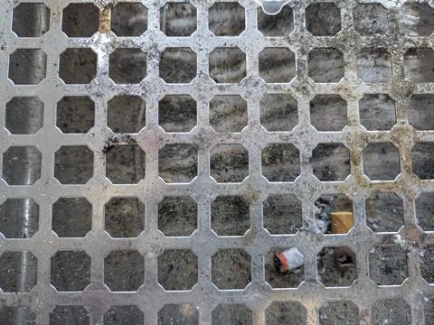 Perforated circle pattern in aluminum iron which is used as a cigarette ashtray Stock Photos