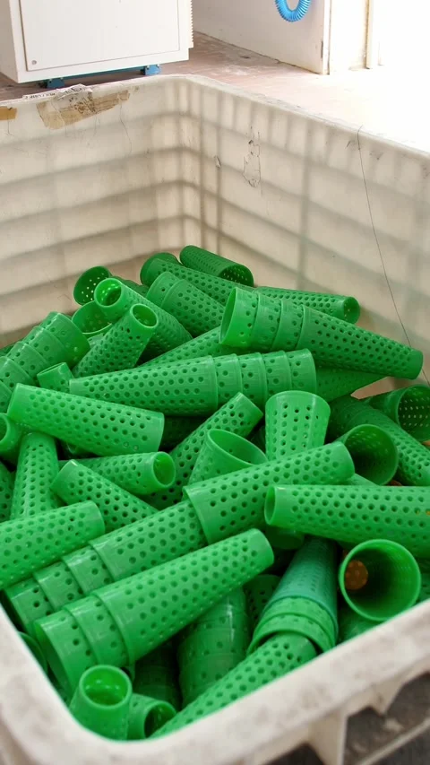 Perforated coloring tubes in a large basket. Textile factory equipment. Textile Stock Footage 321616843
