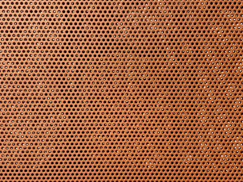 Perforated metal mesh surface featuring a grid pattern Stock Photos