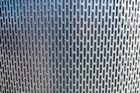 Perforated metal panel displaying repeating elongated slot pattern 스톡 사진