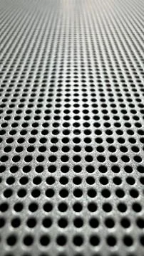 Perforated Metal Sheet Texture Close-Up with Bokeh Stock Photos