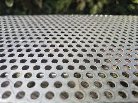 Perforated metal table surface with blurred background Stock Photos