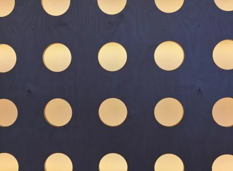 Perforated pattern wooden board with backlight home decor, round holes with s Stock Photos