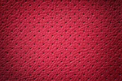 Perforated red leather texture background. Dark backdrop from wrinkle skin. Stock Photos