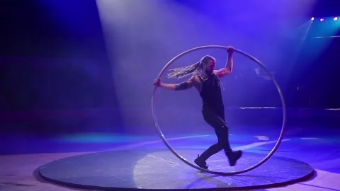 Performance of an acrobat with a ring on stage. Stock Footage 147407417