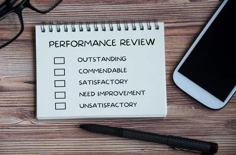 Performance appraisal checklist on notepad with office setting background Stock Photos