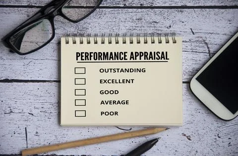 Performance appraisal checklist on notepad with office setting background Stock Photos
