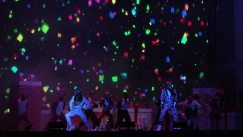 Performance of artists on festive stage with colored smoke on dark background. 動画素材 251772060