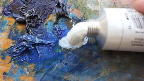 Performance of artwork, a tube of white paint and a palette Stock Footage 84127561