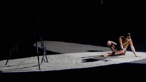 Performance of a female acrobat in a circus. A beautiful acrobat in a bright Stock Footage 168924014