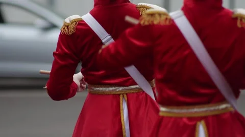 Performance of female drummers with drumsticks in red costumes, background Stockbeeldmateriaal 308629099