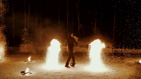 Performance of fire show artists.  Artists wave and control fire Stock Footage 231233666