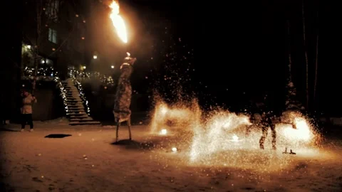 Performance of fire show artists. Artists wave and control the fire Stock Footage 231233782