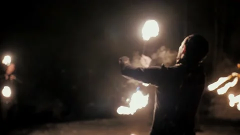 Performance of fire show artists.  Artists wave and control fire Stock Footage 231233787