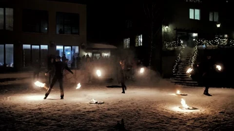 Performance of fire show artists.  Artists wave and control fire Stock Footage 231233834