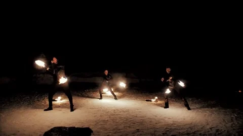 Performance of fire show artists.  Artists wave and control fire Stock Footage 231233867