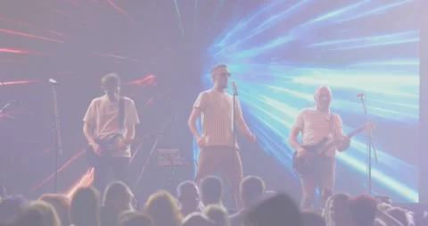 Performance musical group on stage in spotlight. Blue and red light. Vocalist Video stock 205851501