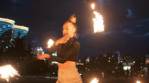Performance or show with fire outdoor. Adult girl moves with flaming torches Stock Footage 120688833