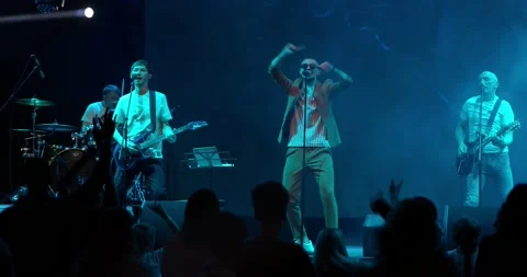Performance of a pop or rock group, music band on stage. Stage neon light and Stock Footage 195544735