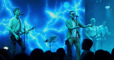 Performance of a pop or rock group, music band on stage. Stage neon light and Stock Footage 197336597
