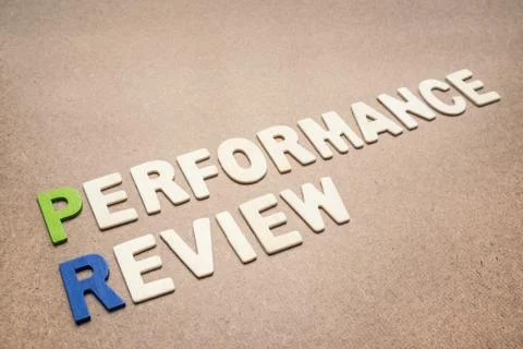 Performance review text on brown background Stock Photos