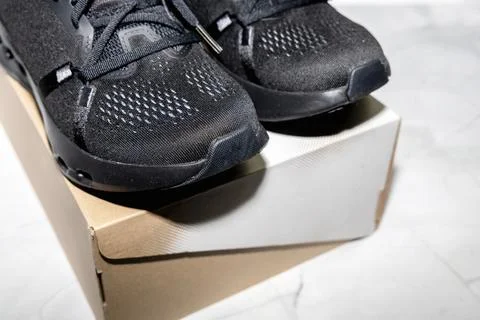 Performance running sneakers presented with simple shoe box. Stock Photos