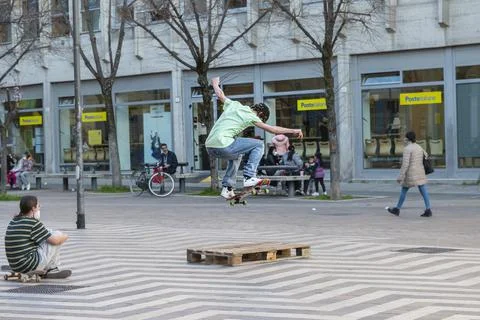 Performance with the skateboard in a square with jumps Stock Photos