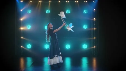 Performance of trained white pigeons. Beautiful woman with long wavy hair in Stock Footage 151606542