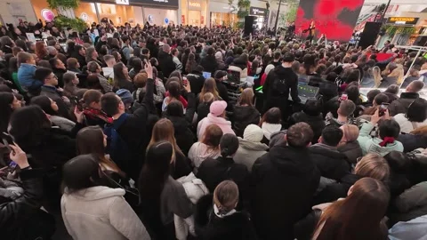 The performance is for Valentine's Day. There is a crowd of young fans. Video stock 329140564