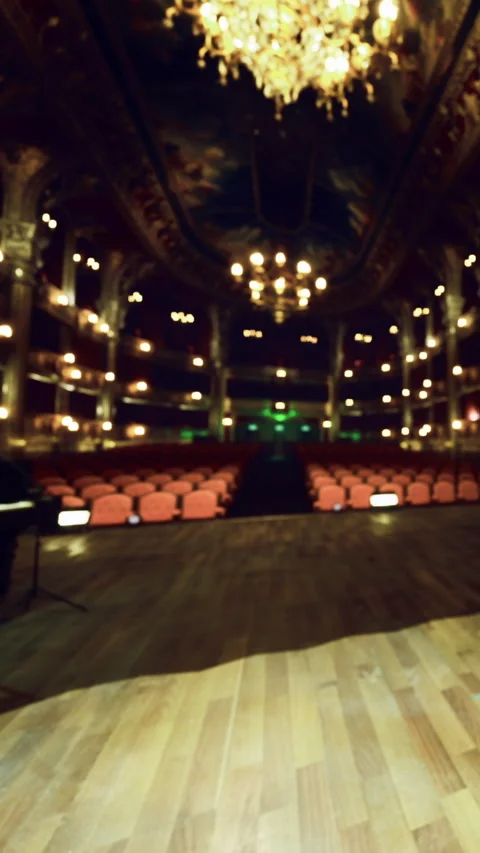 Performance venue with empty seats and stage lighting in evening hours Stock Footage 331754671
