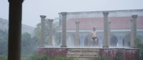 Performer dancing in the rain Stock Footage 85808404