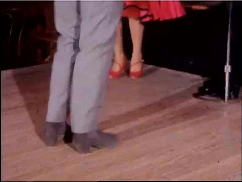 A performer dressed as a flapper dances on a stage and an actor slides down a 스톡 동영상 75071755