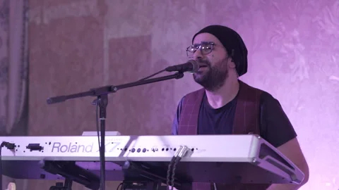 A performer with glasses and a hat on his head Stock Footage 266602594