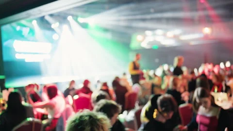 Performer glows with bright lights. Speaker stands out under powerful Stock Footage 332245472