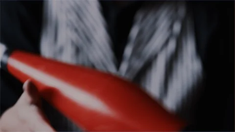 Performer juggling battern trick in slow motion Stock Footage 101417962