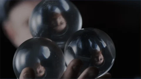 Performer juggling crystal balls in hand Stock Footage 101512551